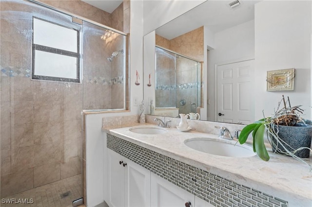 bathroom with vanity and a shower with shower door