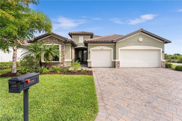 mediterranean / spanish home with french doors, a front lawn, and a garage