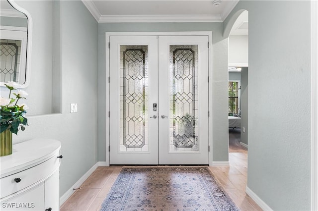 foyer featuring french doors and crown molding