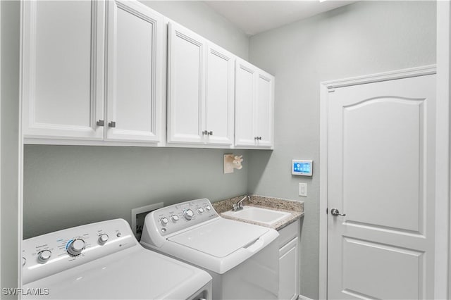 washroom with washer and clothes dryer, sink, and cabinets