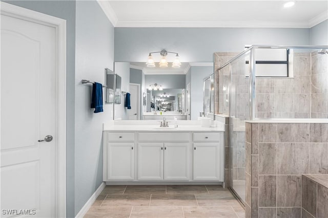 bathroom with ornamental molding, vanity, and a shower with shower door