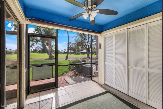 unfurnished sunroom featuring a ceiling fan