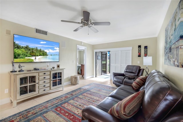 living room with visible vents, light tile patterned flooring, crown molding, baseboards, and ceiling fan