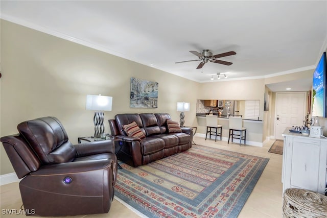 living room featuring light tile patterned floors, baseboards, ceiling fan, and crown molding