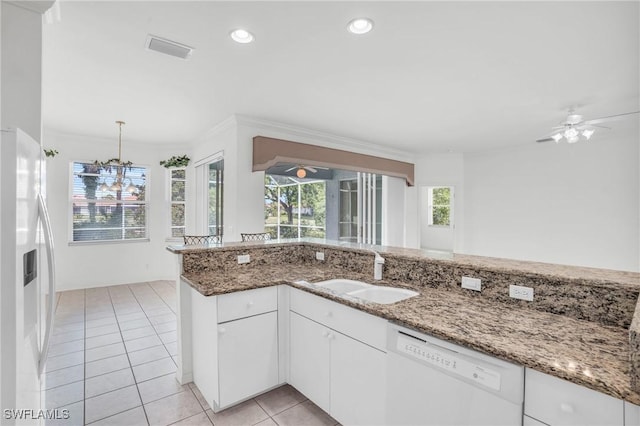 kitchen featuring light tile patterned flooring, sink, white cabinetry, stone counters, and white appliances