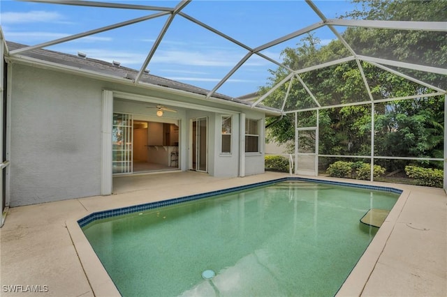 view of pool featuring ceiling fan, a lanai, and a patio area