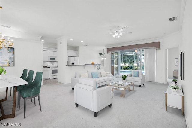 carpeted living room with ornamental molding and ceiling fan with notable chandelier