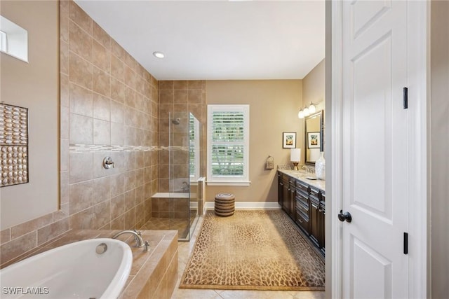 bathroom with tile patterned floors, vanity, and shower with separate bathtub