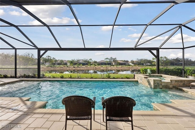 view of pool with an in ground hot tub, a water view, glass enclosure, and a patio area