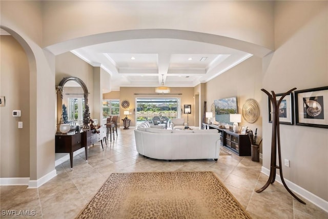 living room with french doors, coffered ceiling, beamed ceiling, a towering ceiling, and ornamental molding