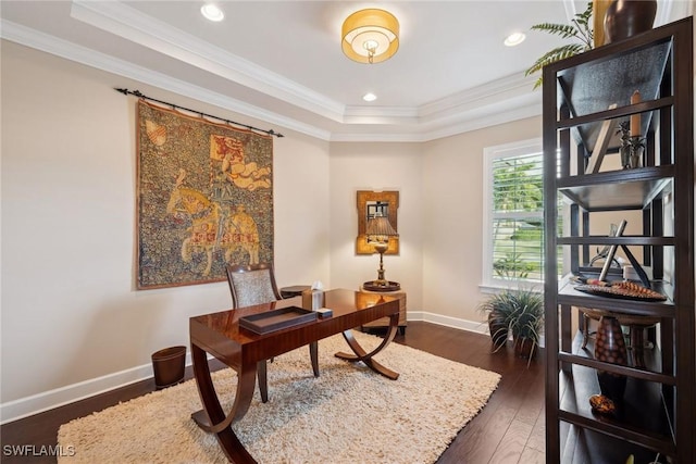 office space featuring dark hardwood / wood-style floors, a raised ceiling, and crown molding