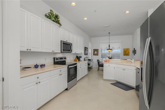 kitchen featuring stainless steel appliances, sink, light tile patterned floors, white cabinets, and hanging light fixtures