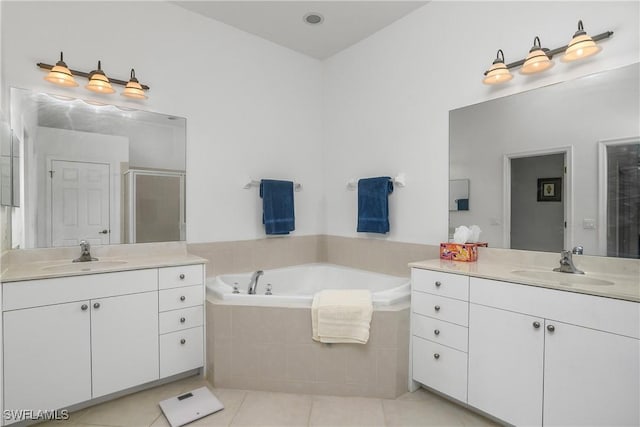 bathroom with vanity, tile patterned flooring, and plus walk in shower