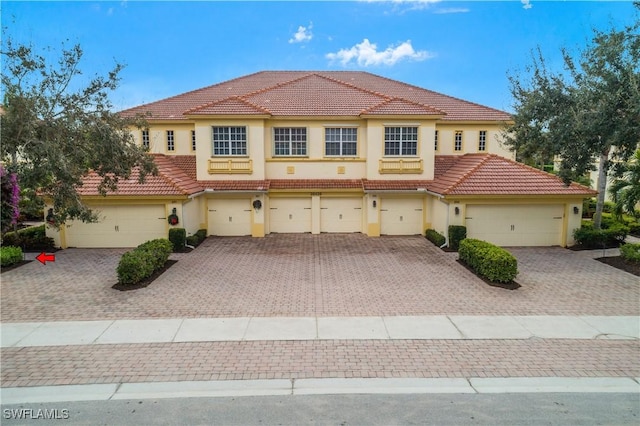 mediterranean / spanish house with a garage