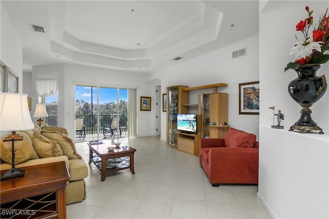 living room featuring a raised ceiling