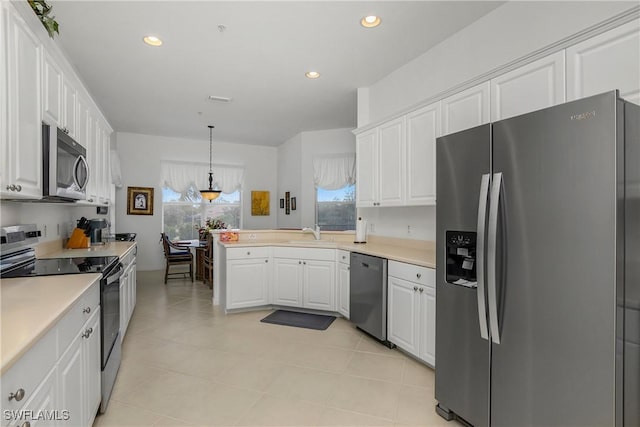 kitchen featuring sink, stainless steel appliances, kitchen peninsula, decorative light fixtures, and white cabinets