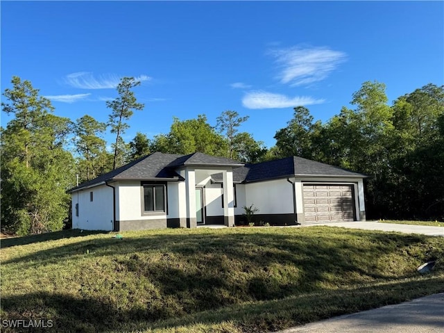 view of front of house with a garage and a front yard