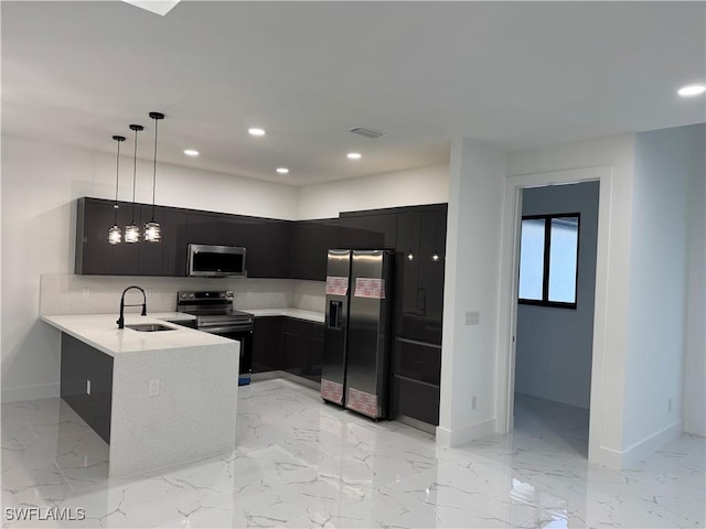 kitchen featuring sink, kitchen peninsula, hanging light fixtures, and appliances with stainless steel finishes