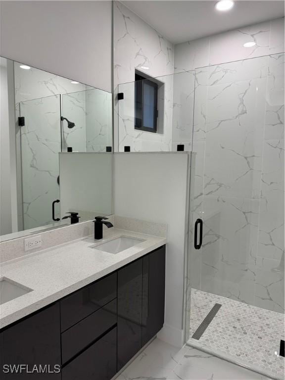 bathroom with vanity and a shower with door