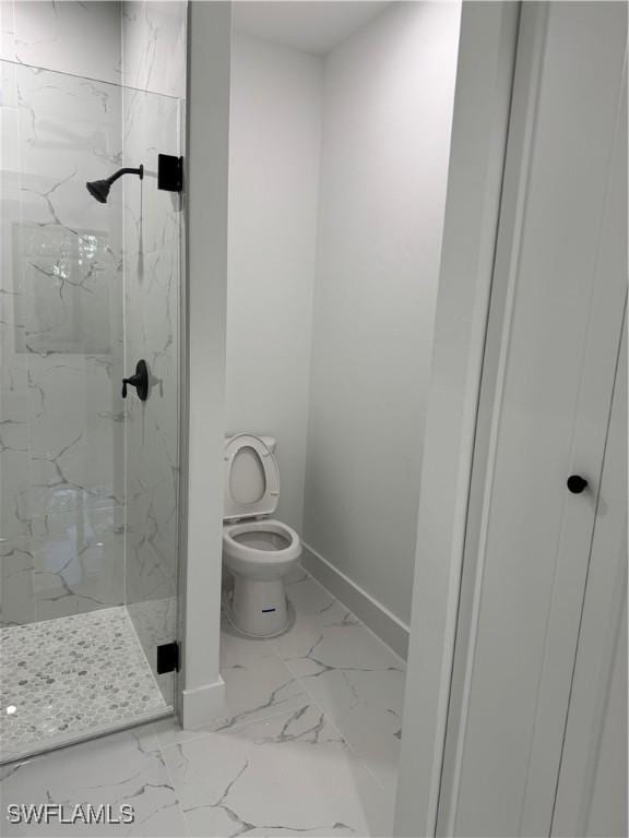 bathroom with toilet and a shower with shower door