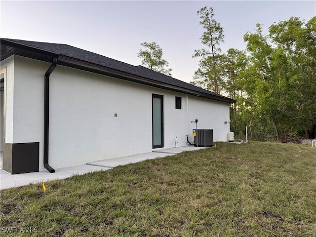 back of property featuring a yard and cooling unit