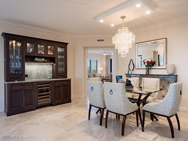 dining area featuring an inviting chandelier, wine cooler, and ornamental molding