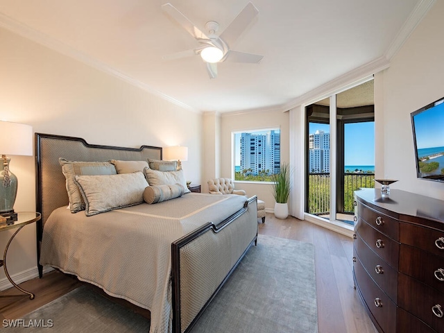 bedroom featuring ceiling fan, access to exterior, wood-type flooring, and ornamental molding