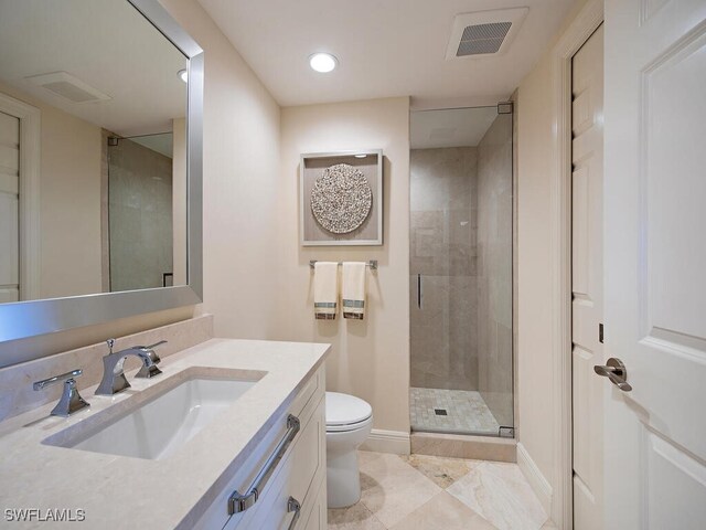 bathroom featuring tile patterned flooring, vanity, toilet, and a shower with shower door