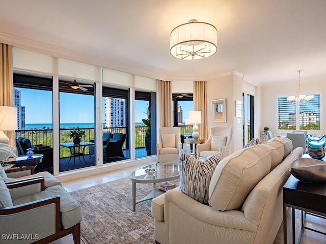 living room with a water view, light tile patterned floors, crown molding, and an inviting chandelier