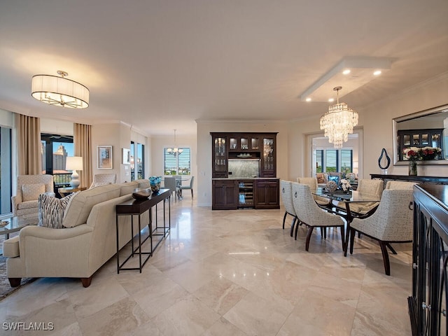 dining area featuring crown molding, plenty of natural light, and a notable chandelier