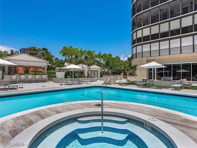 view of swimming pool with a gazebo, a patio area, and a hot tub