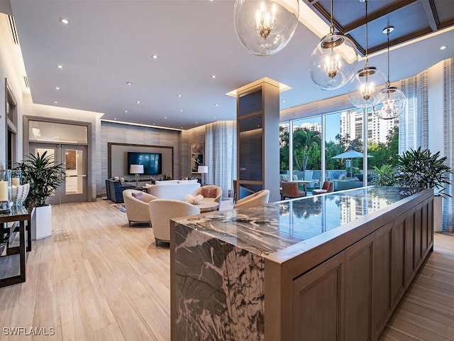 kitchen featuring french doors, decorative light fixtures, light hardwood / wood-style floors, and a notable chandelier