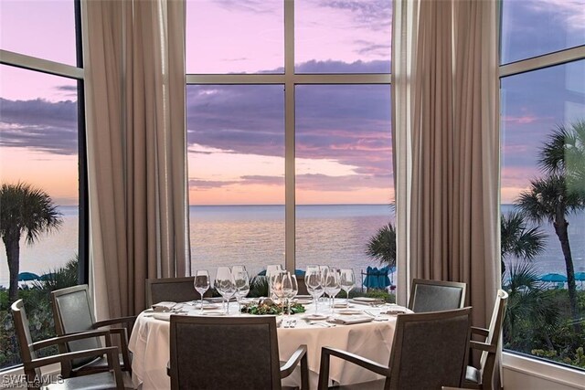 dining room featuring expansive windows and a water view