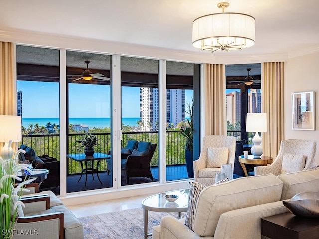 interior space with ceiling fan with notable chandelier and a water view