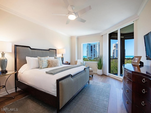 bedroom featuring ceiling fan, ornamental molding, access to exterior, and hardwood / wood-style floors