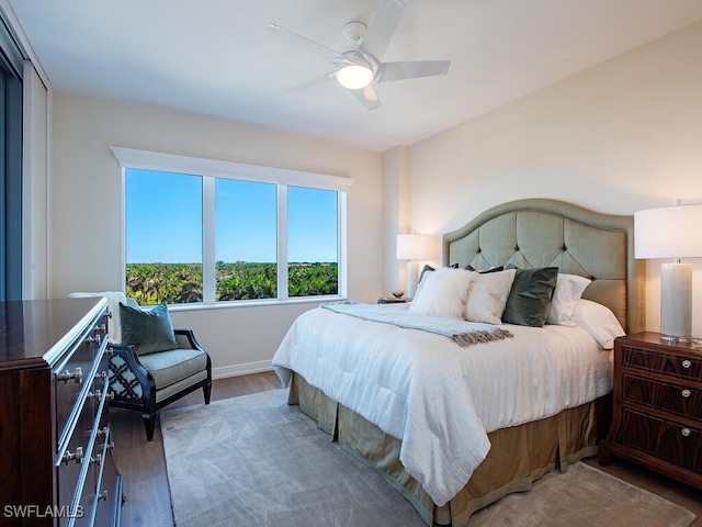 bedroom featuring hardwood / wood-style flooring and ceiling fan