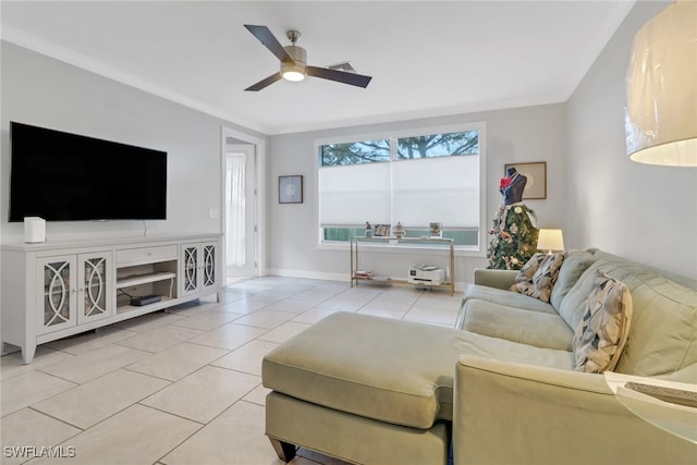 living room featuring ceiling fan, light tile patterned flooring, baseboards, and crown molding