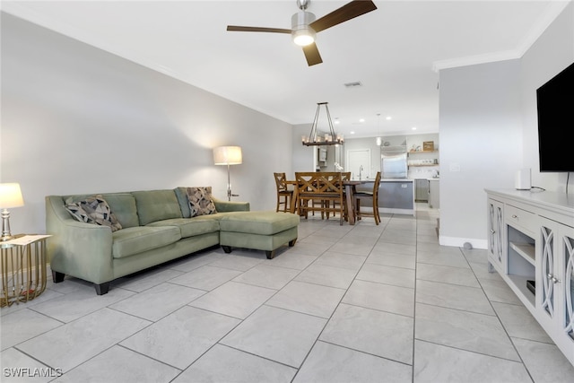 living area with visible vents, ornamental molding, light tile patterned flooring, ceiling fan, and baseboards