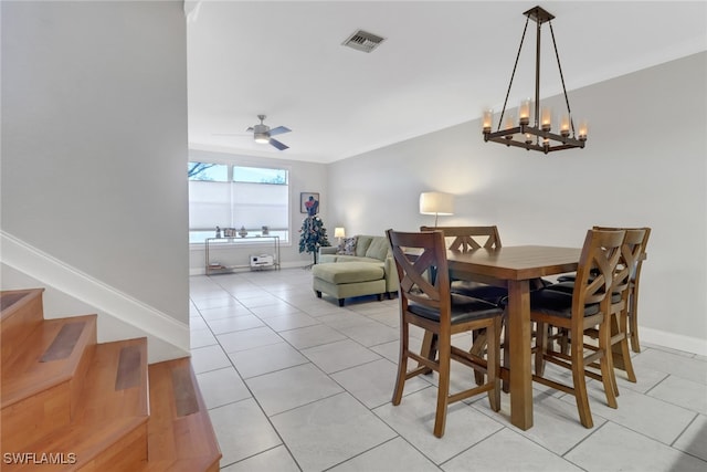 dining area featuring light tile patterned flooring, baseboards, visible vents, and ceiling fan with notable chandelier