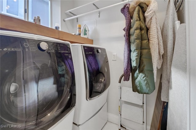 clothes washing area featuring laundry area and separate washer and dryer