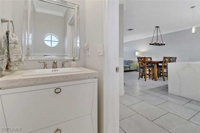 bathroom featuring crown molding, visible vents, vaulted ceiling, vanity, and tile patterned floors