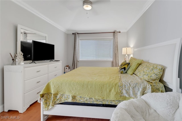 bedroom featuring ornamental molding, ceiling fan, and wood finished floors