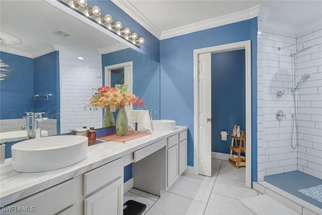 bathroom featuring a shower stall, ornamental molding, and a sink