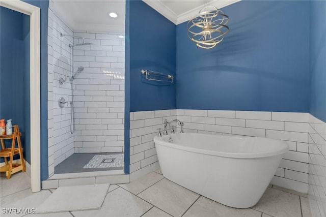 full bath featuring tile patterned floors, crown molding, a freestanding tub, a shower stall, and tile walls