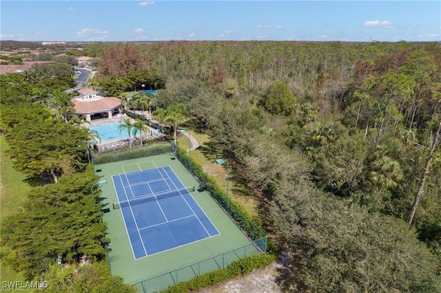 birds eye view of property with a forest view