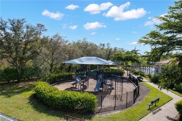 surrounding community with playground community, fence, and a lawn