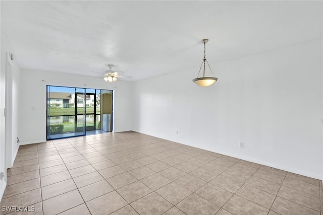 spare room featuring ceiling fan and light tile patterned floors