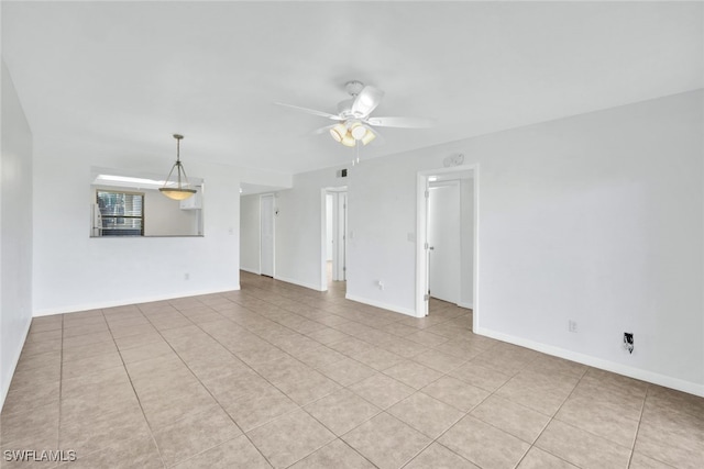 tiled spare room featuring ceiling fan