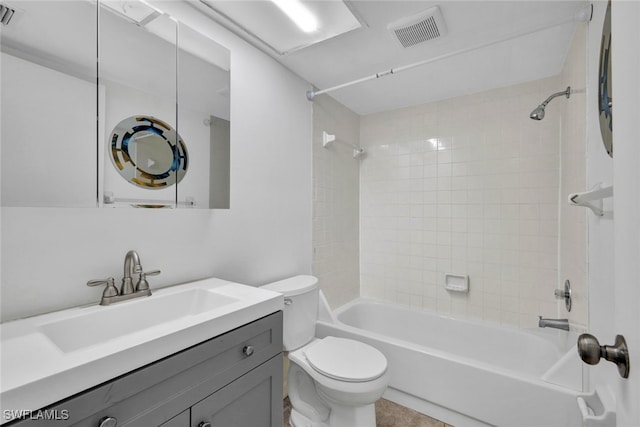 full bathroom featuring tile patterned flooring, vanity, tiled shower / bath combo, and toilet