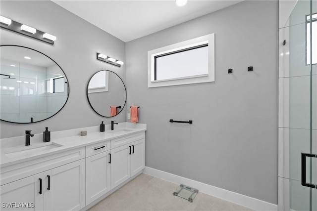 bathroom with tile patterned floors, plenty of natural light, vanity, and a shower with door